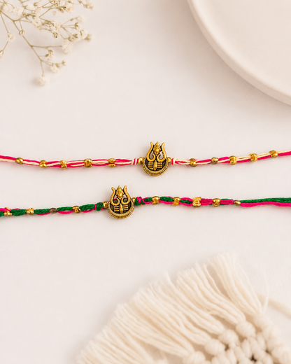 Green-Pink Trishoola Rakhi Set Pack of 2 | Tilak Set Included